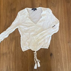 White blouse with white lace accents and tassels lightly worn